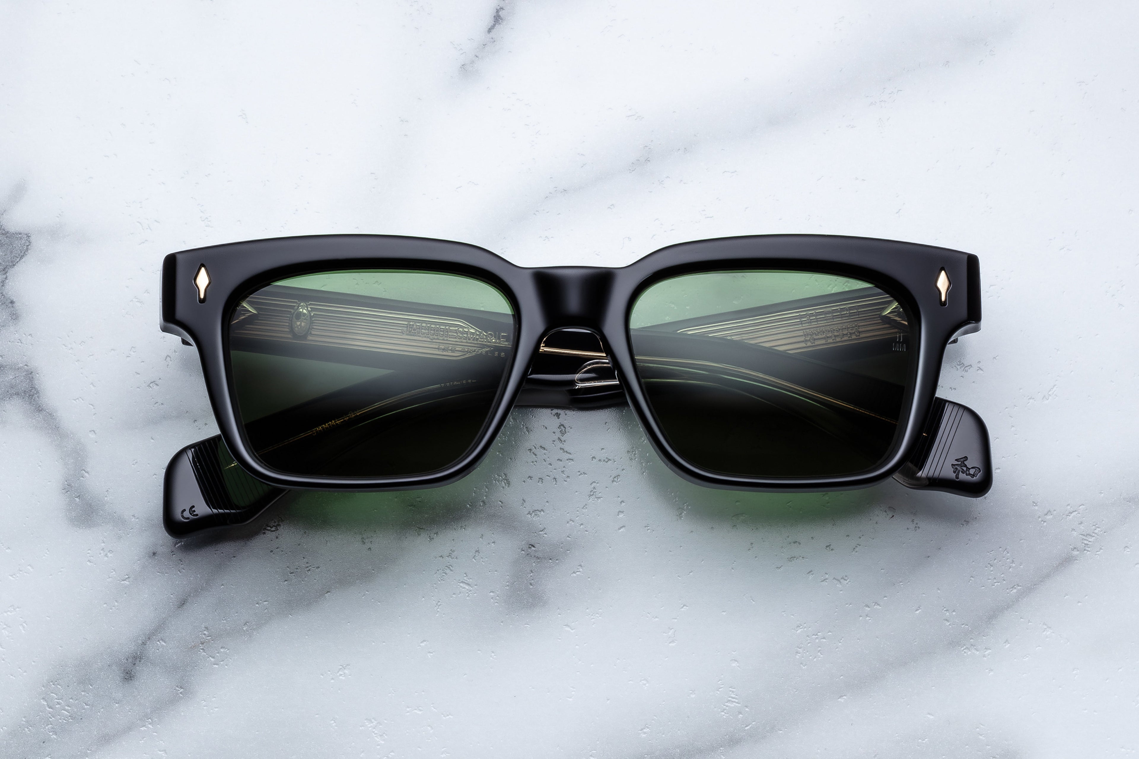 Jacques Marie Mage Molino sunglasses with sleek black frames and tinted lenses, front view showing stylish design.