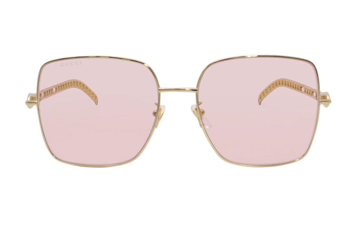 Gucci 724 sunglasses with black frames and tinted lenses, displayed on a website screenshot.