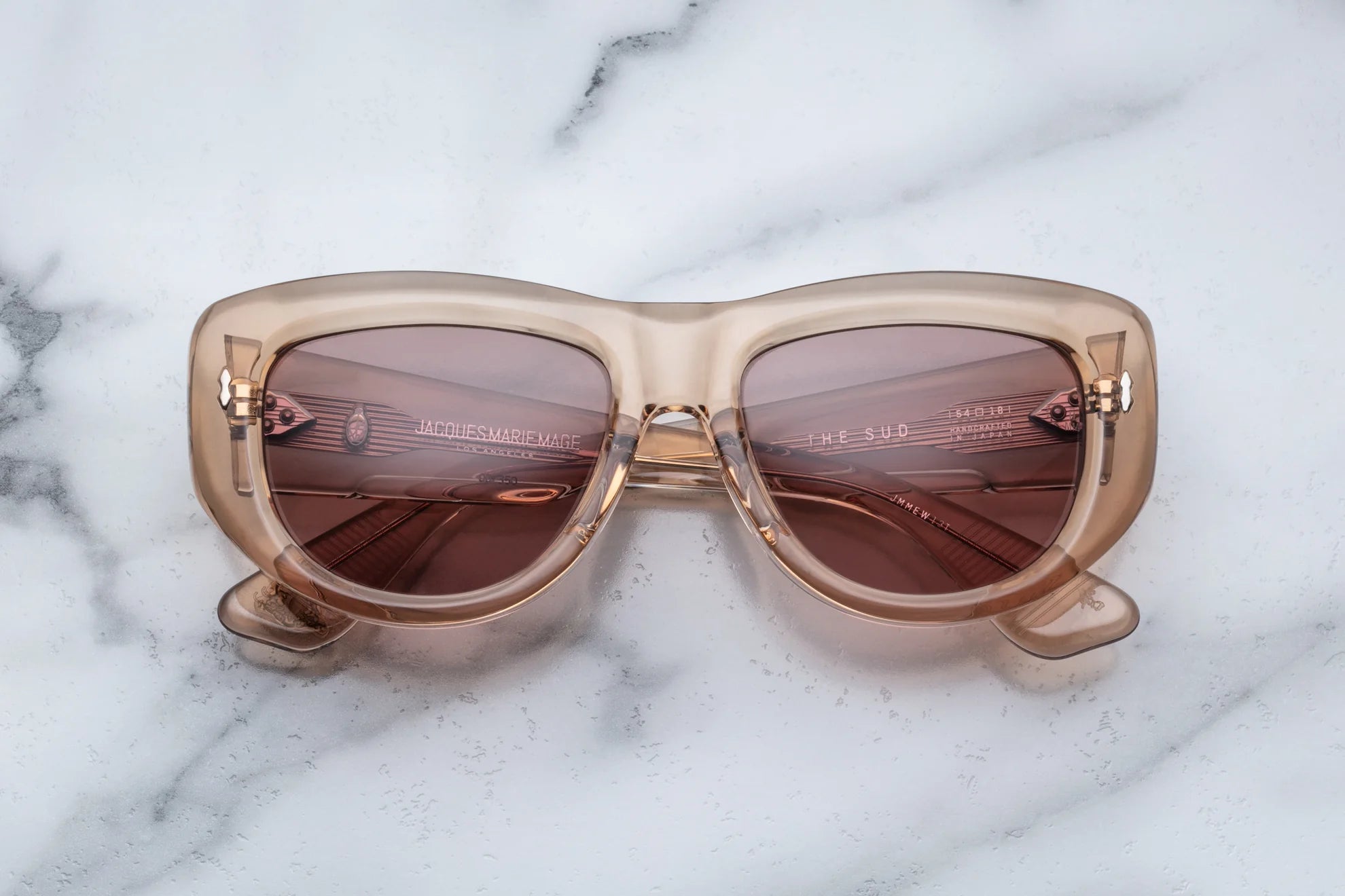Close-up of Jacques Marie Mage The Sud Simone sunglasses showing the front view with sleek black frame and tinted lenses.