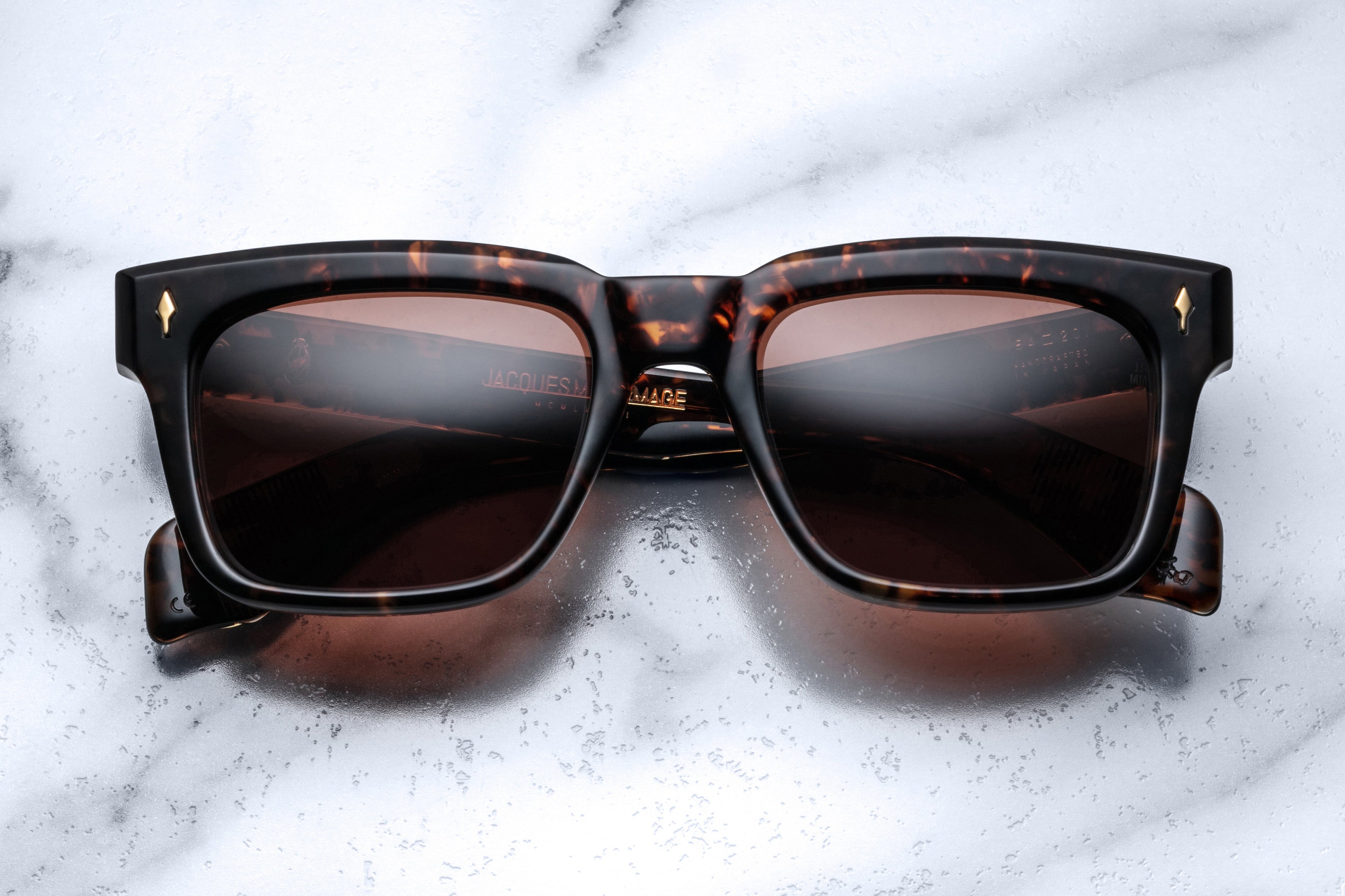 Jacques Marie Mage Torino sunglasses with tortoise frames and dark lenses, stylish eyewear on a clean background.