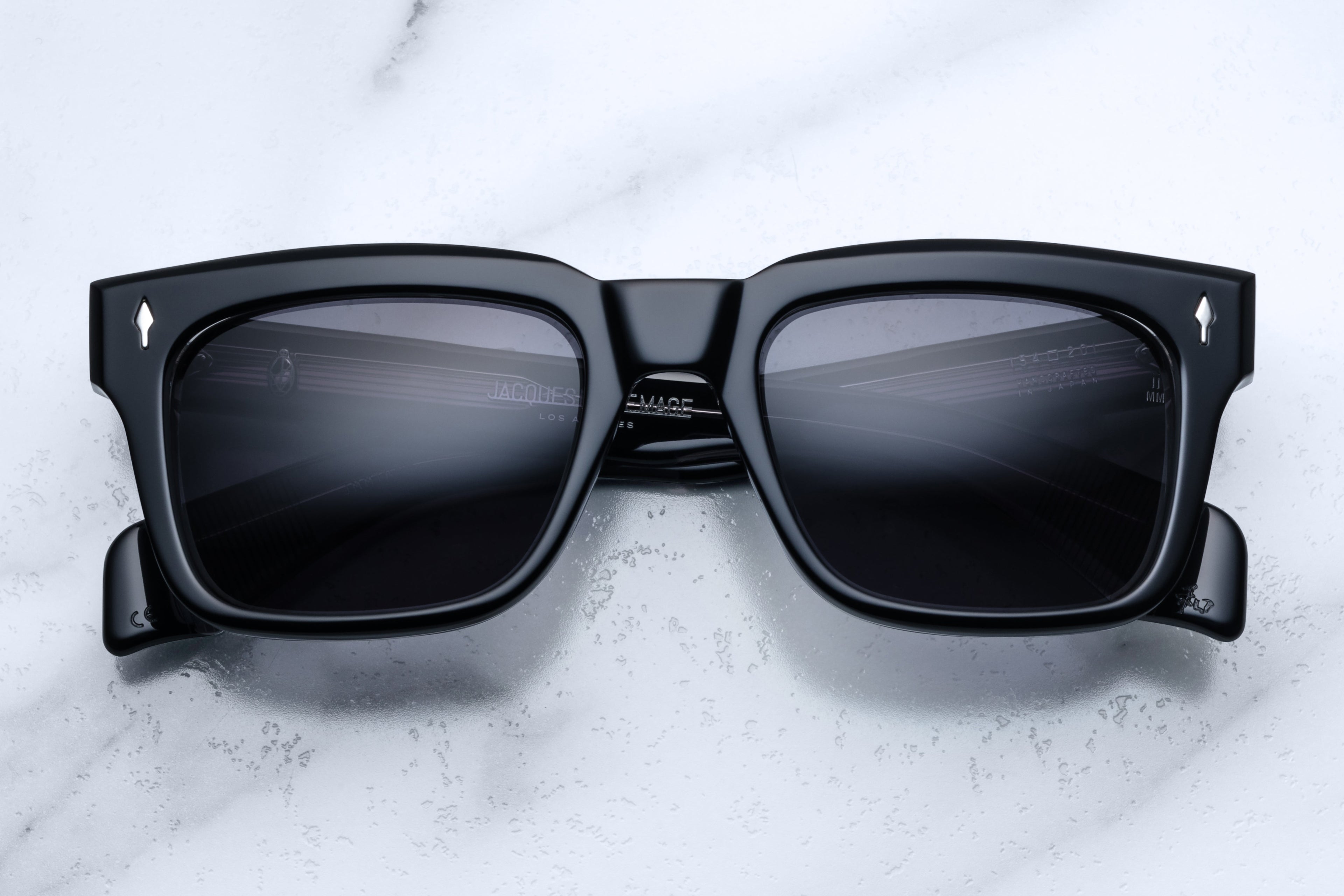 Jacques Marie Mage Torino Apollo sunglasses with sleek black frames and dark tinted lenses, front view.