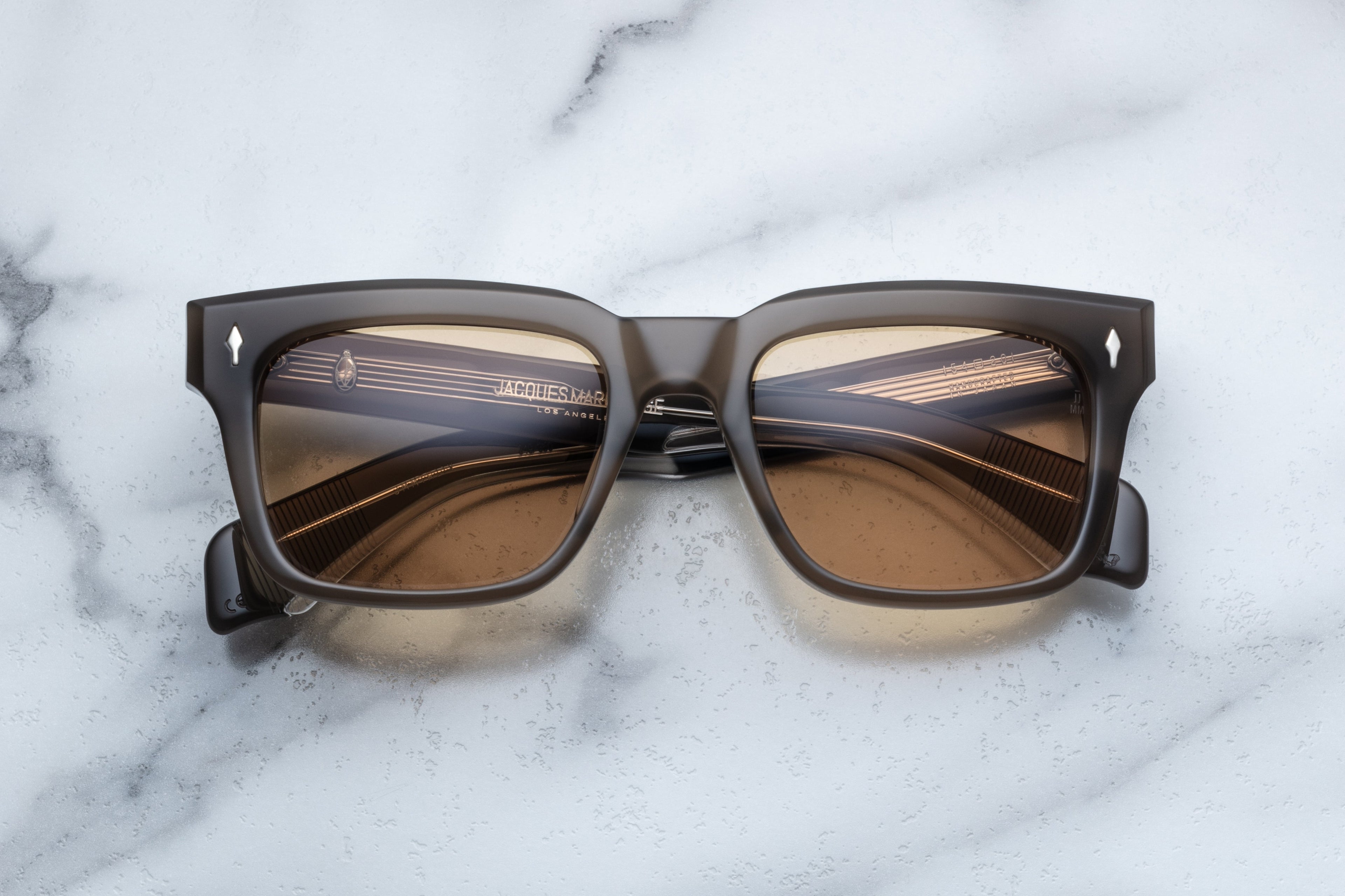 Jacques Marie Mage Torino sunglasses with colosseum-inspired design, featuring sleek frames and tinted lenses.