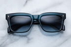 Jacques Marie Mage Torino sunglasses with indigo frames and clear lenses, front view showcasing stylish eyewear design.