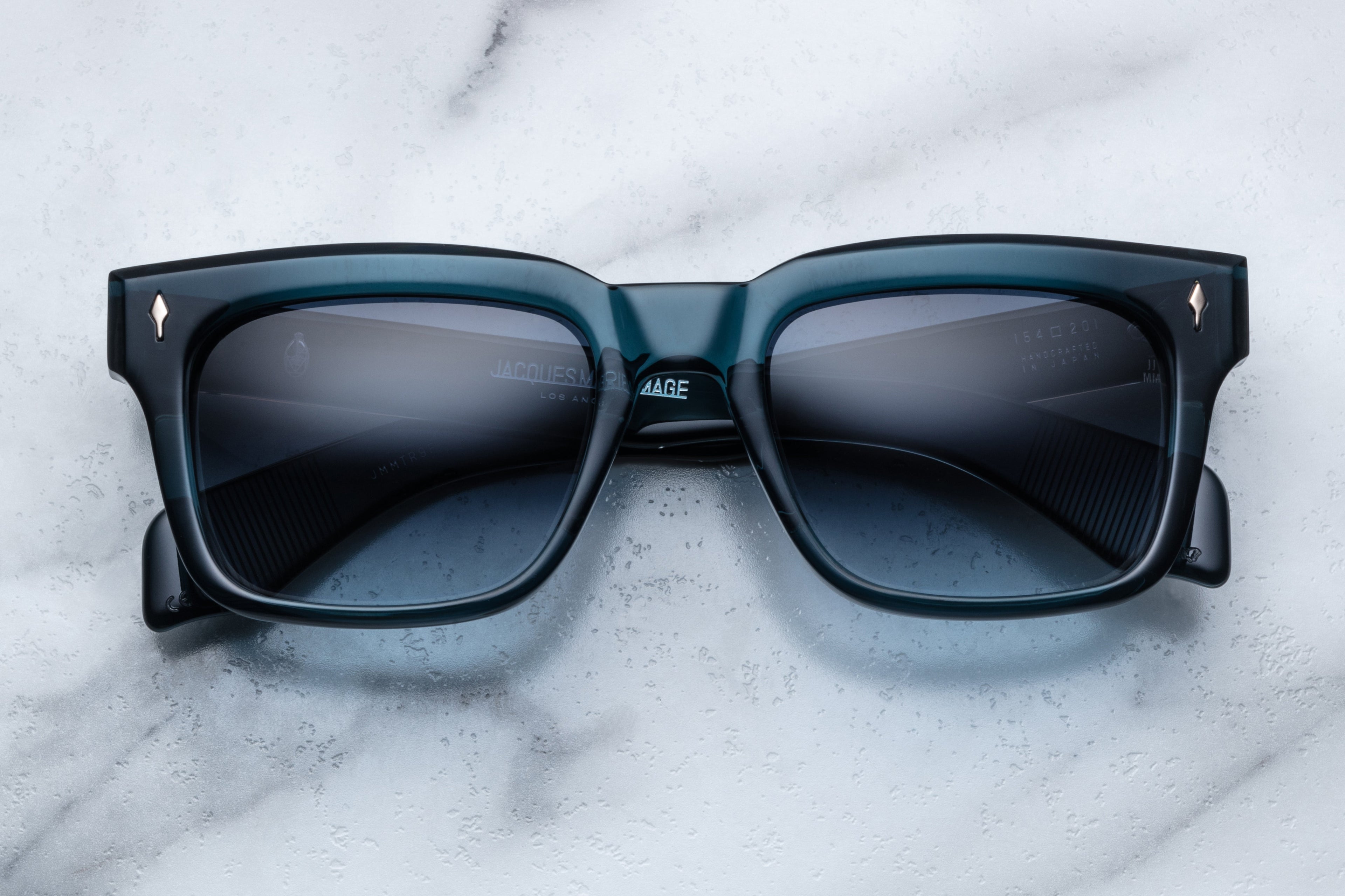 Jacques Marie Mage Torino sunglasses with indigo frames and clear lenses, front view showcasing stylish eyewear design.