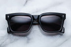 Jacques Marie Mage Torino Noir sunglasses with black frames and clear lenses, front view showing sleek, modern design.