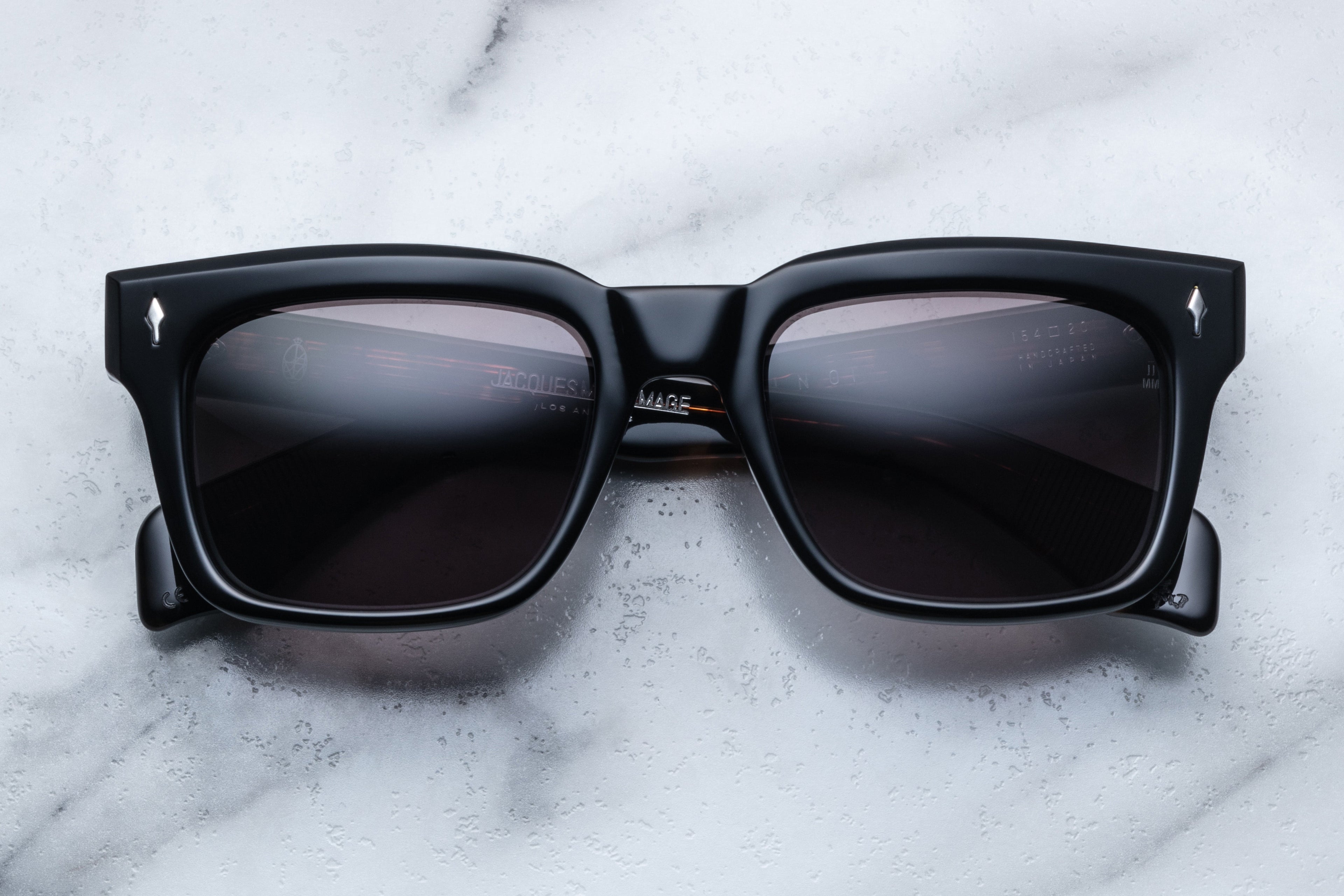 Jacques Marie Mage Torino Noir sunglasses with black frames and clear lenses, front view showing sleek, modern design.