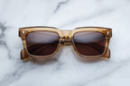 Jacques Marie Mage Torino sunglasses with ocre-colored frames and clear lenses, front view showing stylish eyewear design.