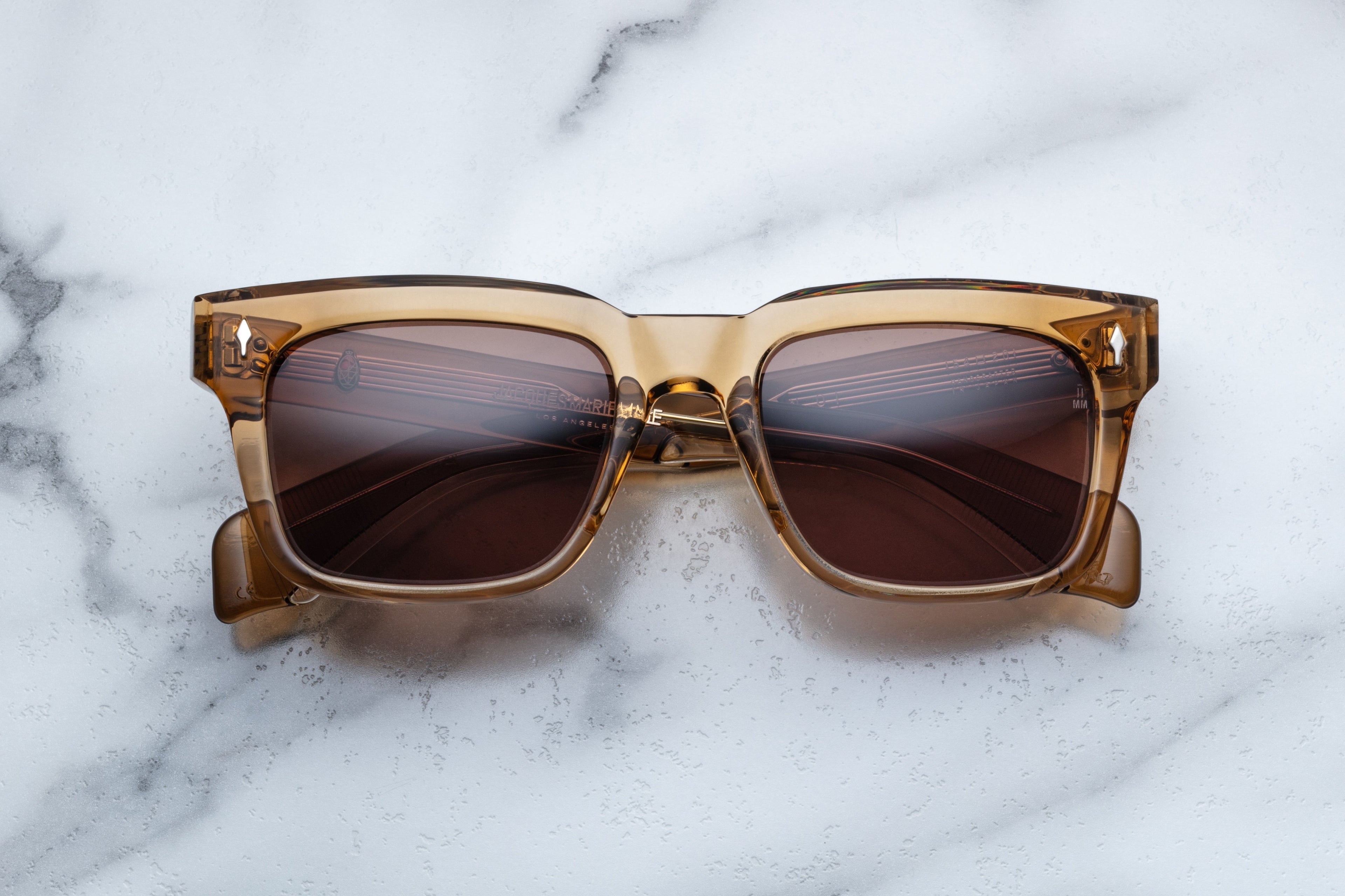 Jacques Marie Mage Torino sunglasses with ocre-colored frames and clear lenses, front view showing stylish eyewear design.