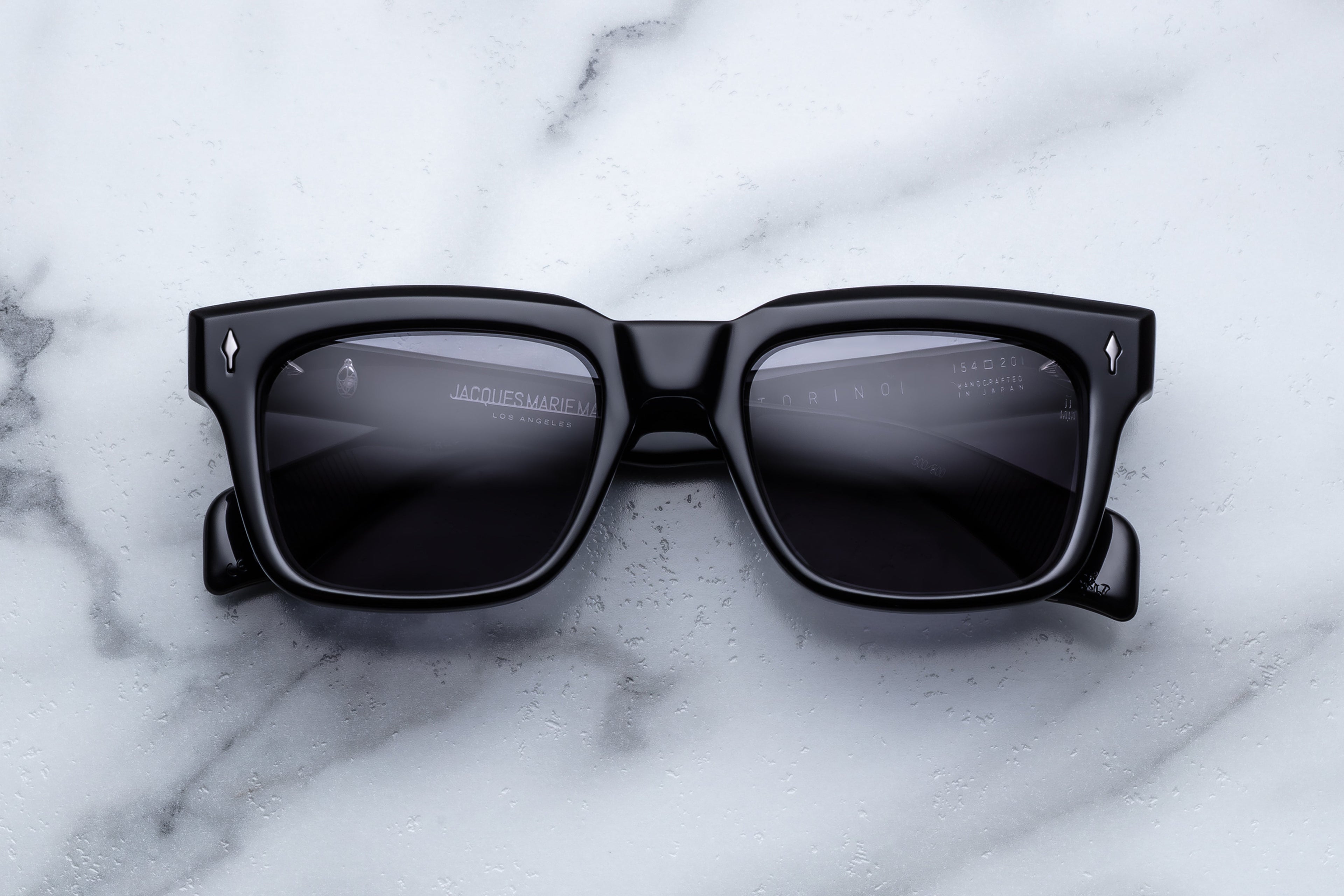 Jacques Marie Mage Torino Raven sunglasses with rounded frames and dark lenses, front view showing stylish design.