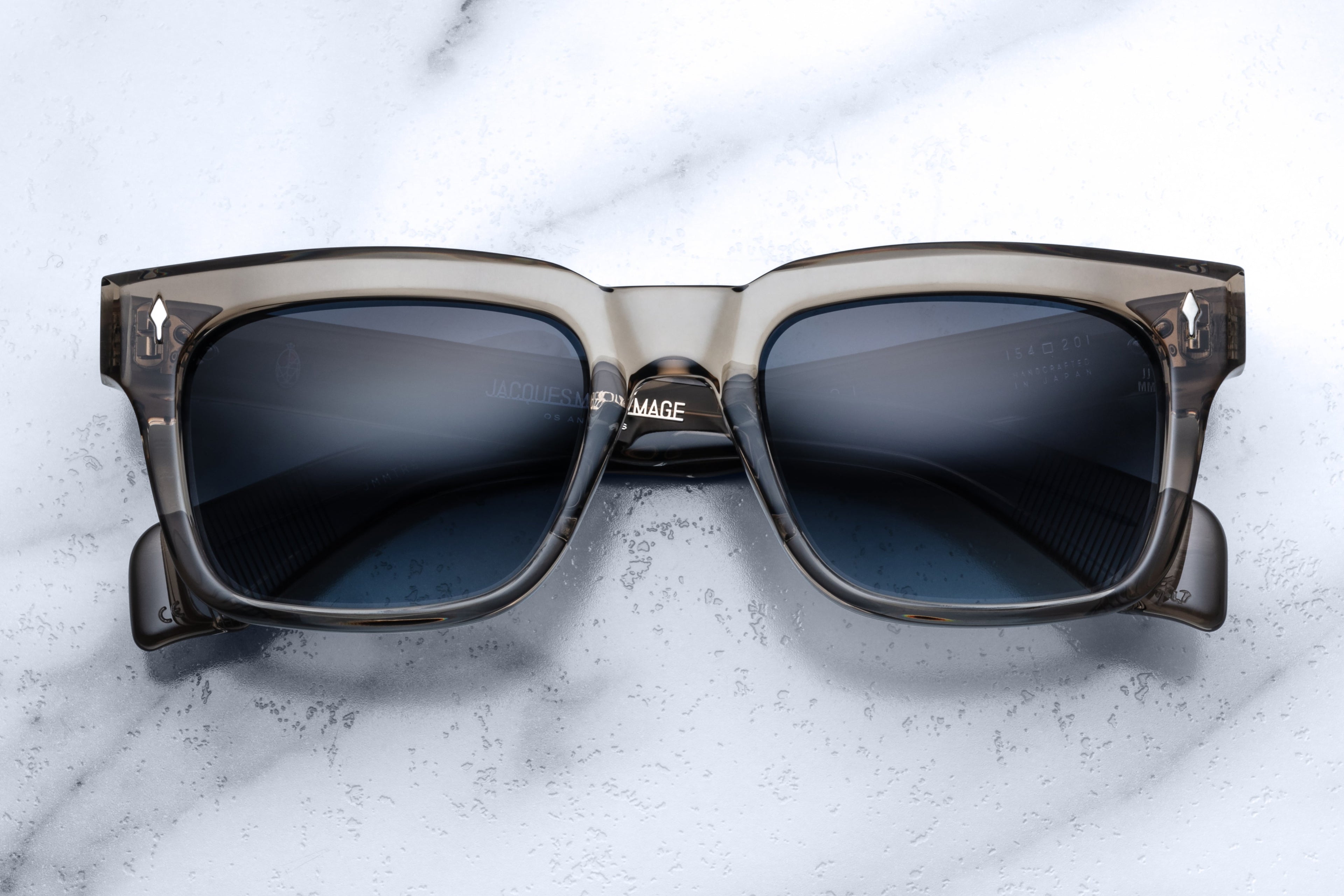 Jacques Marie Mage Torino taupe sunglasses with rounded frames and clear lenses, front view showcasing stylish design.