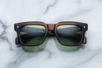 Jacques Marie Mage Torino sunglasses with round frames and dark tinted lenses, close-up front view.