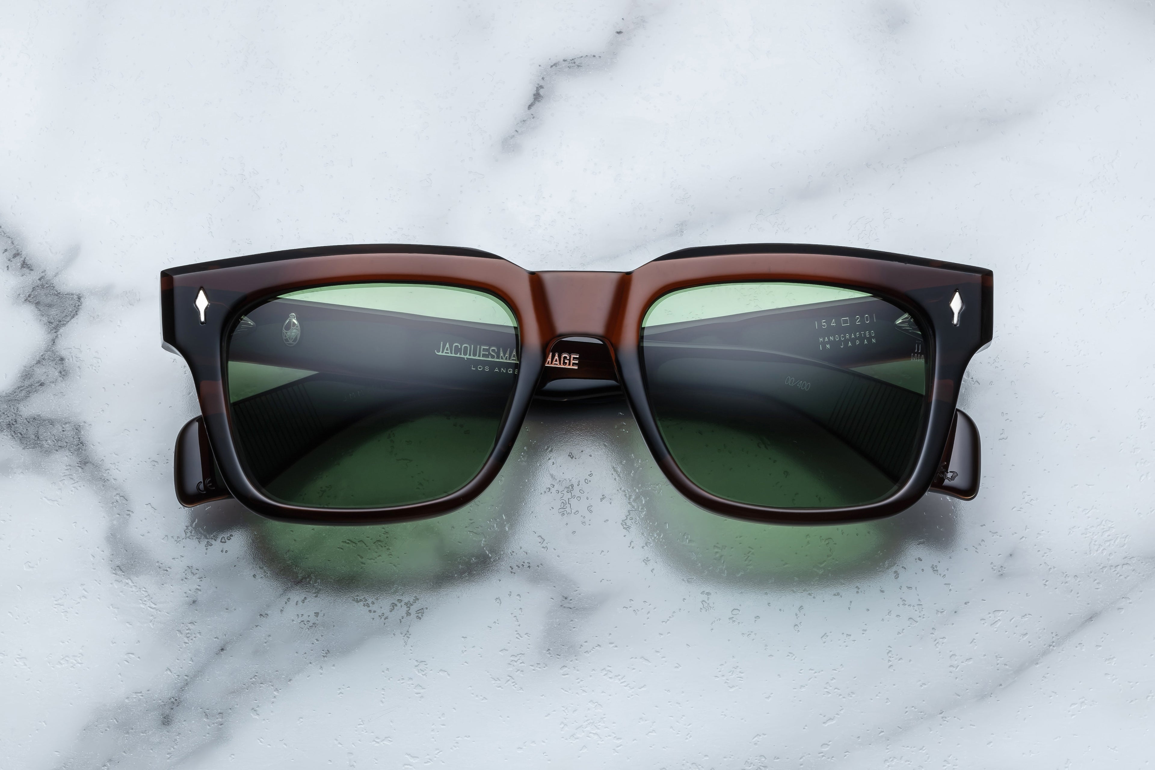 Jacques Marie Mage Torino sunglasses with round frames and dark tinted lenses, close-up front view.