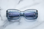 Jacques Marie Mage VITO sunglasses with pampas-colored frames and clear lenses, front view showing sleek, modern design.