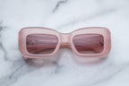 Jacques Marie Mage VITO sunglasses with peach-colored frames and dark lenses, front view showing stylish, modern design.