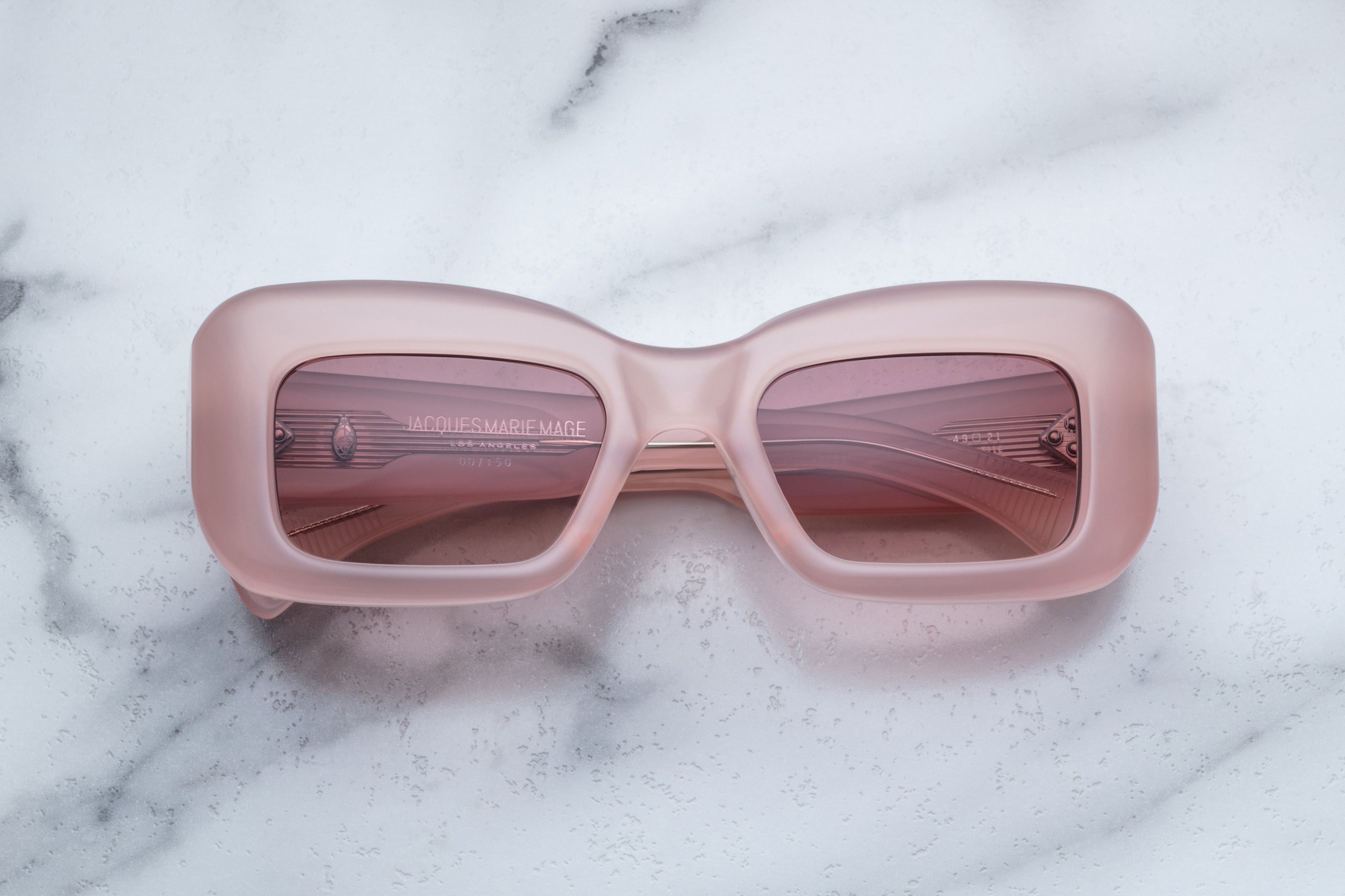 Jacques Marie Mage VITO sunglasses with peach-colored frames and dark lenses, front view showing stylish, modern design.