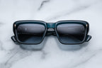 Jacques Marie Mage Walker sunglasses with indigo frames and clear lenses, front view showing stylish design and sleek shape.