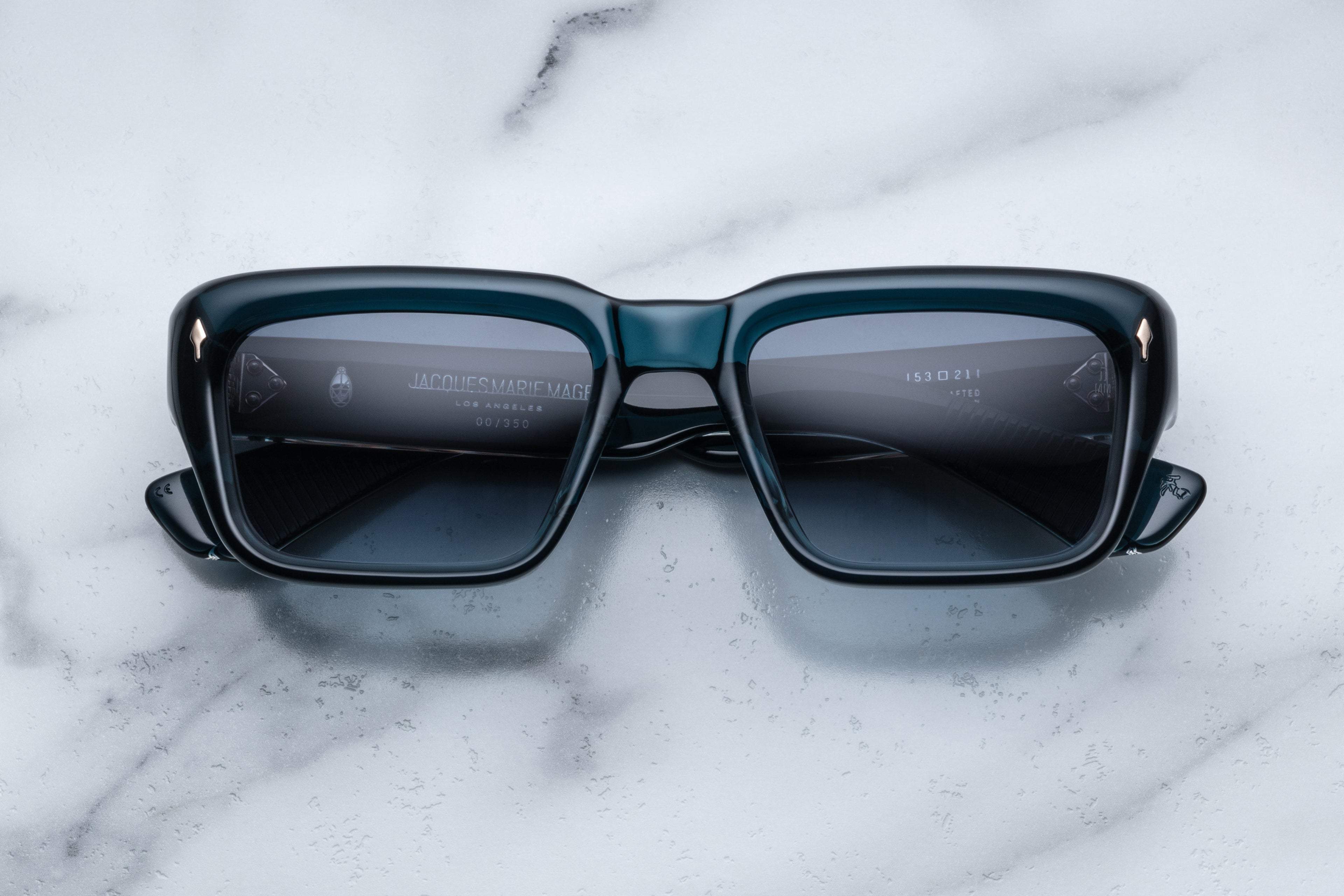 Jacques Marie Mage Walker sunglasses with indigo frames and clear lenses, front view showing stylish design and sleek shape.