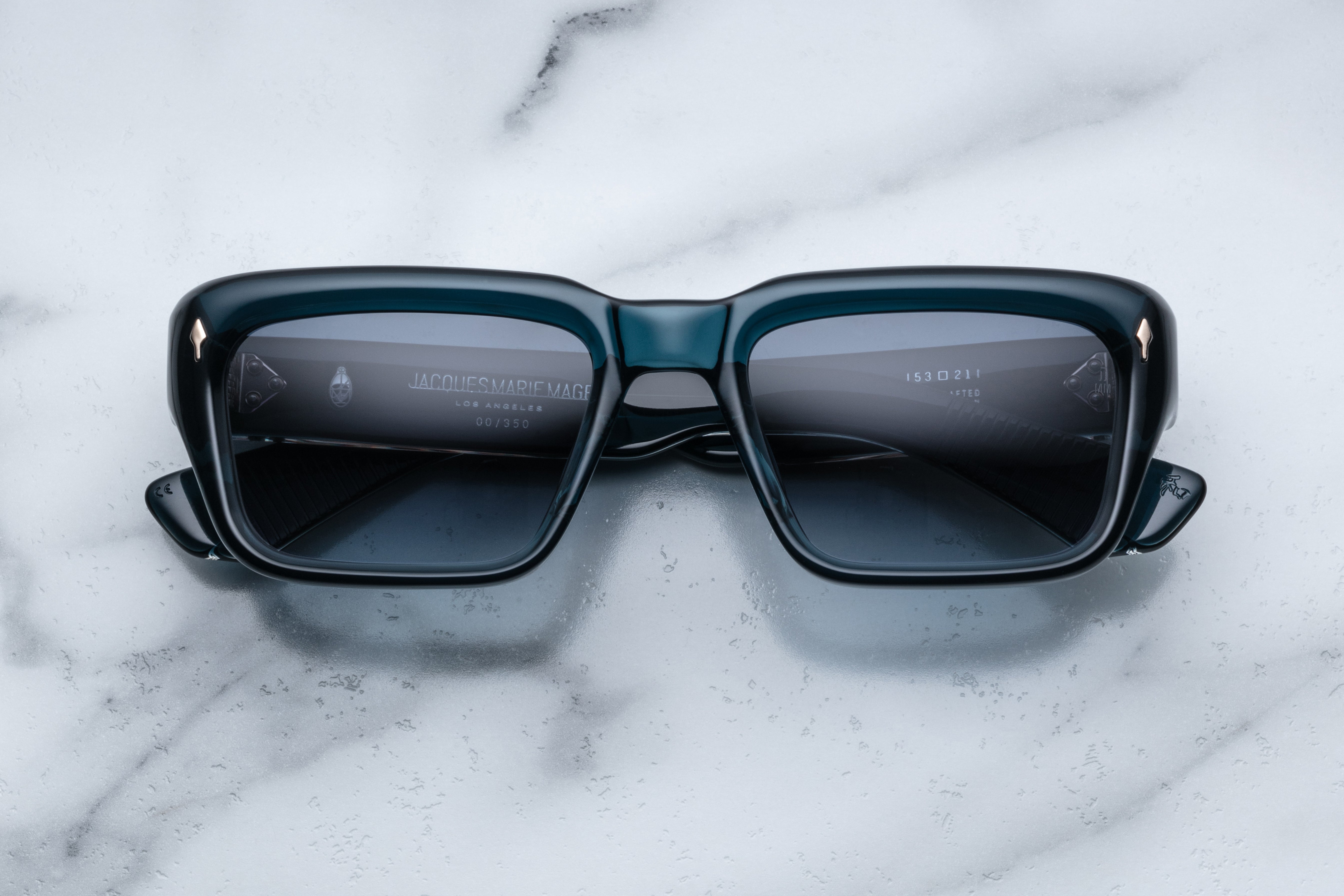 Jacques Marie Mage Walker sunglasses with indigo frames and clear lenses, front view showing stylish design and sleek shape.