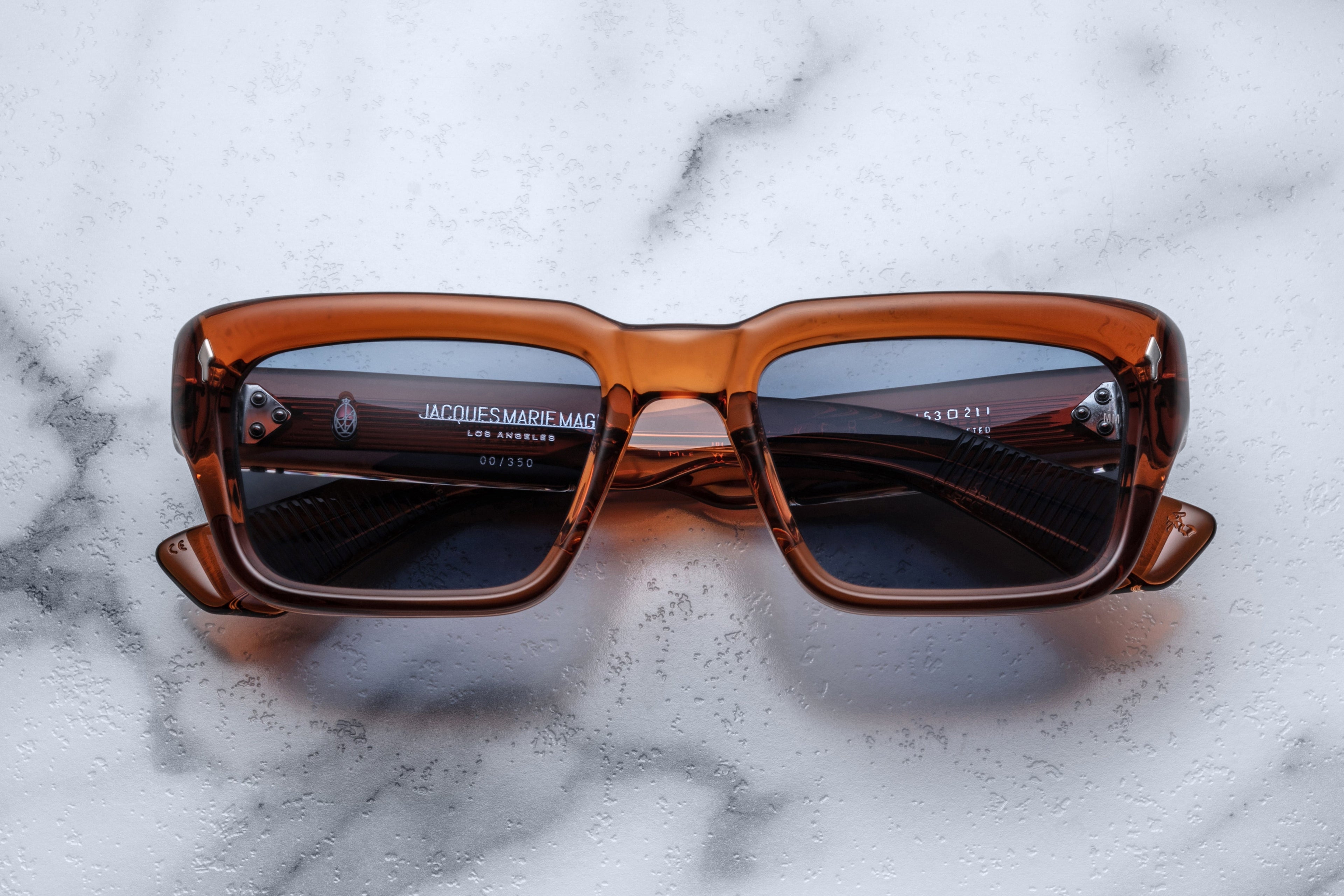 Jacques Marie Mage Walker sunglasses with natural root beer-colored frames and clear lenses, front view showing stylish design.