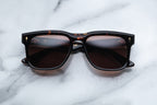 Jacques Marie Mage Wesley sunglasses with transparent agar-colored frames and clear lenses, shown from the front view.