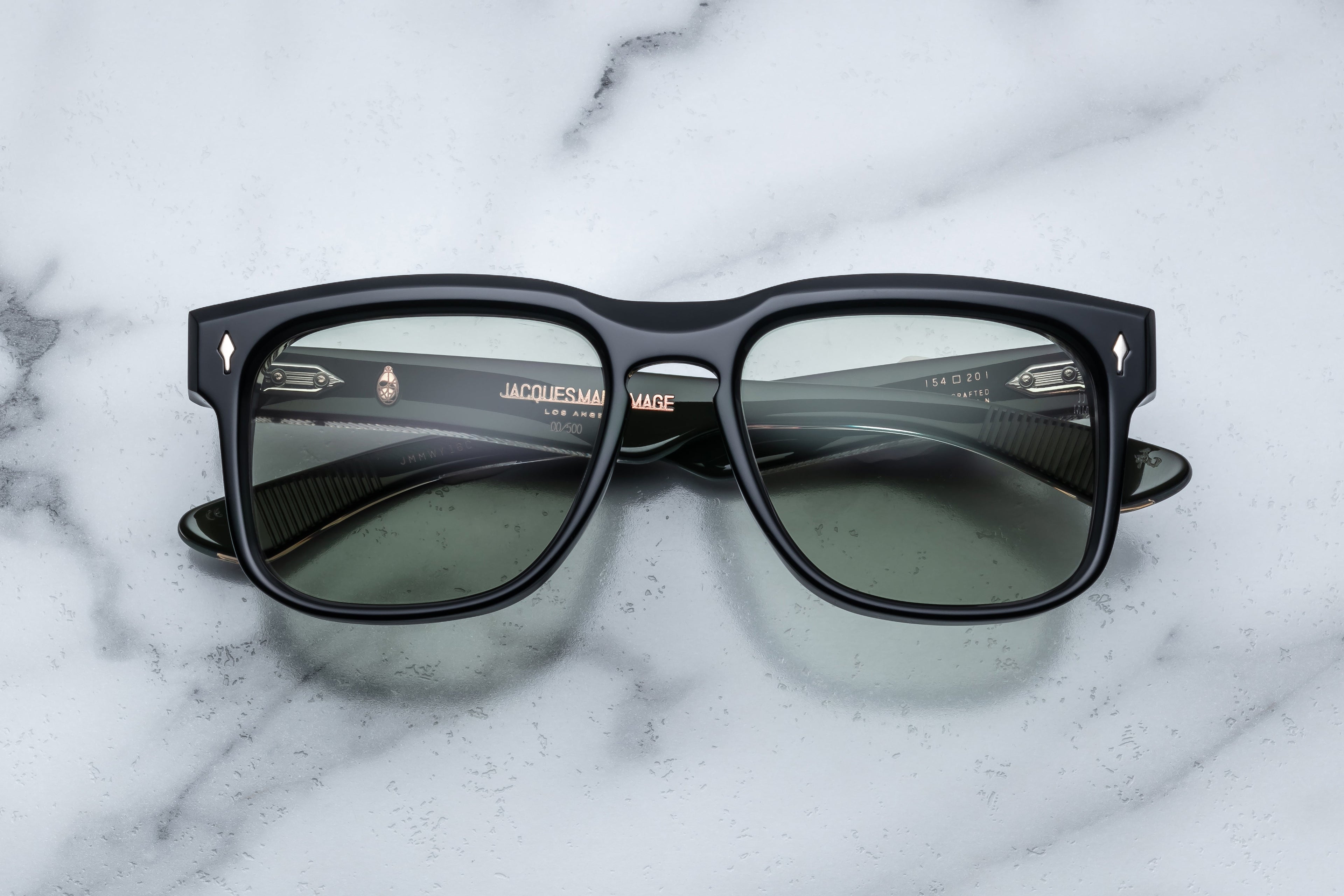Jacques Marie Mage Wesley sunglasses with bold cobra-patterned frames and clear lenses, front view showing stylish design.
