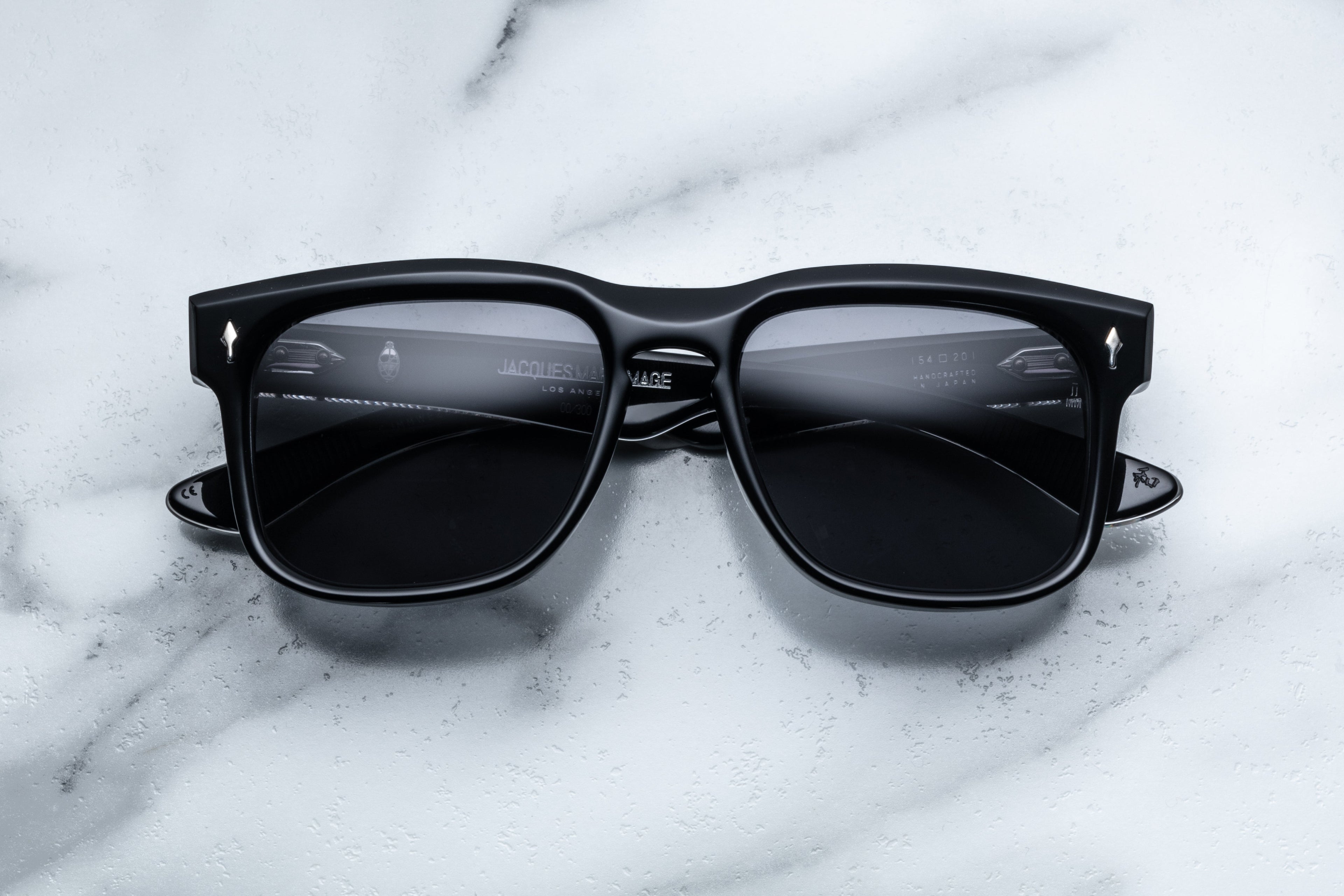 Jacques Marie Mage Wesley sunglasses with shadow-tinted lenses and sleek black frames, front view.