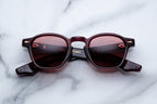 Jacques Marie Mage Zephirin sunglasses with amarena-colored frames and clear lenses, front view showing stylish design