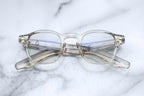 Jacques Marie Mage Zephirin beige optical glasses with round frames and clear lenses, front view.