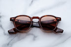 Jacques Marie Mage Zephirin Bourbon sunglasses with rounded frames and dark tinted lenses, front view showing stylish design.