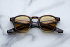 Jacques Marie Mage Zephirin Hazel sunglasses with round frames and tinted lenses, viewed from the front.