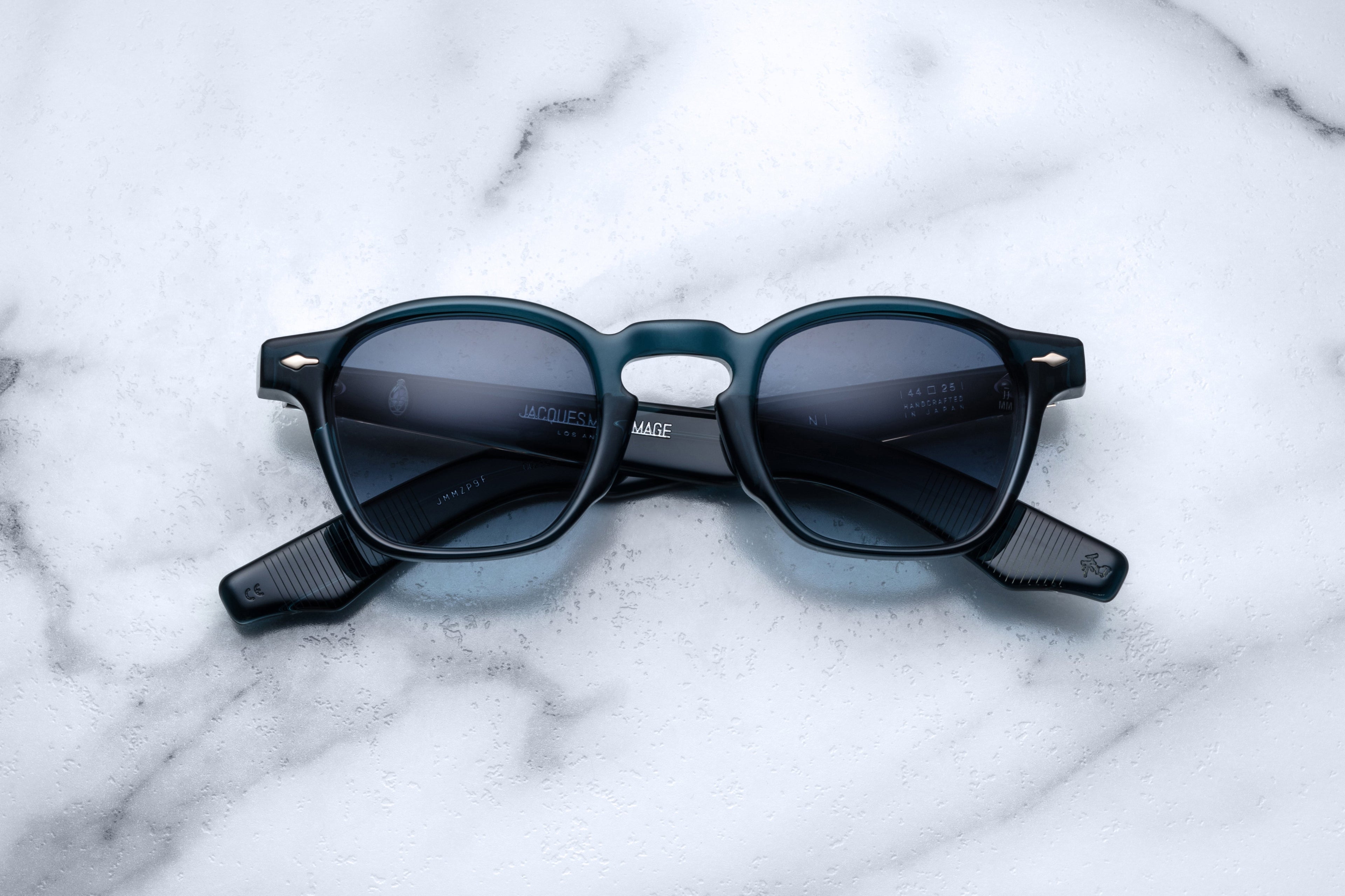 Jacques Marie Mage Zephirin sunglasses with indigo frames and clear lenses, front view showing stylish, modern design.