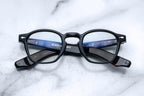Jacques Marie Mage Zephirin Noir optical glasses with round black frames and clear lenses, front view.