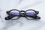 Jacques Marie Mage Zephirin Obscure RX optical glasses with round frames and dark-colored temples, front view.