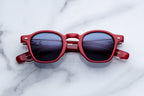 Jacques Marie Mage Zephirin sunglasses with rounded black frames and dark lenses, front view.
