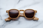 Jacques Marie Mage Zephirin sunglasses with tan frames and dark lenses, front view showing stylish design and craftsmanship.