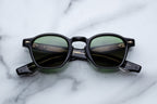 Jacques Marie Mage Zephirin Venom sunglasses with rounded frames and dark tinted lenses, close-up front view.