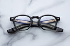Jacques Marie Mage Zephirin Venom RX optical glasses with clear lenses and sleek black frames, front view.