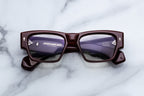 Jacques Marie Mage Zimmerman RX optical glasses in Bordeaux color, front view showing sleek frames and clear lenses.