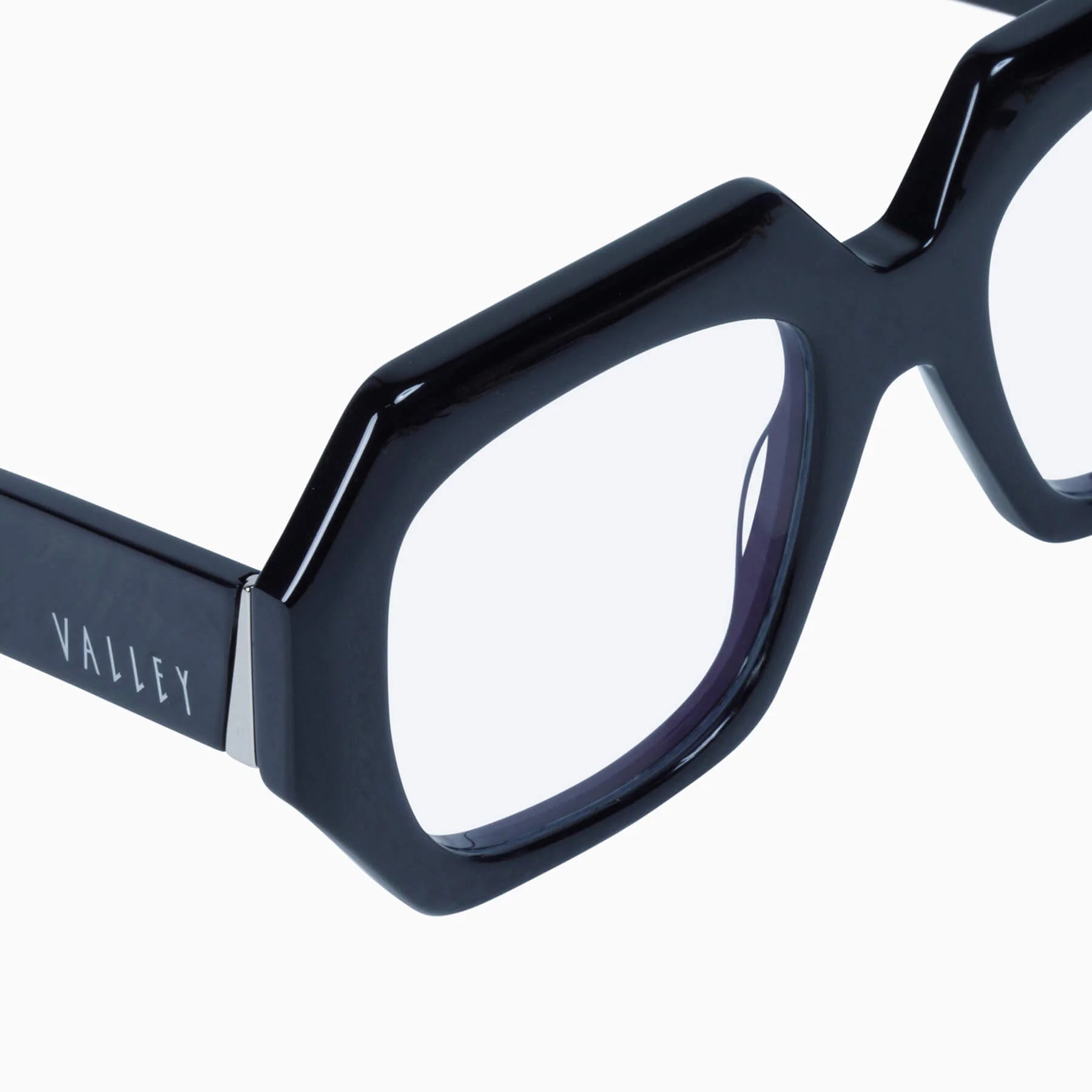 Valley Eyewear Monolith sunglasses with glossy black frame and clear lenses, close-up view of the stylish design.