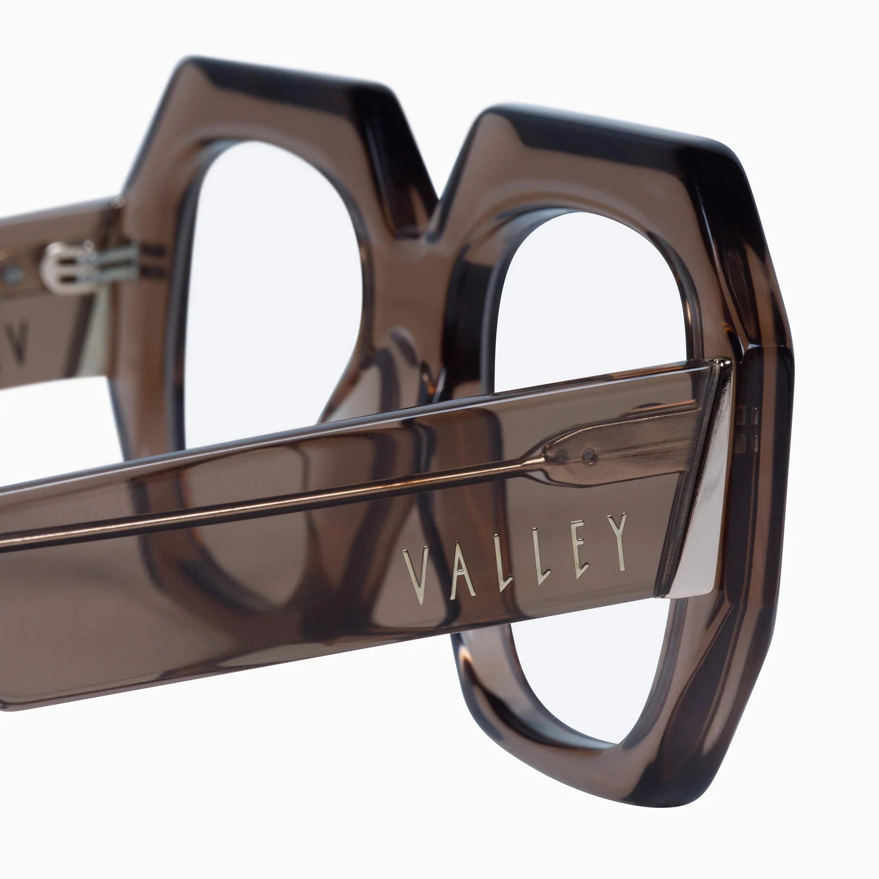 Valley Eyewear Monolith sunglasses with transparent mocha-colored frames and clear lenses, showcasing modern, stylish eyewear design.